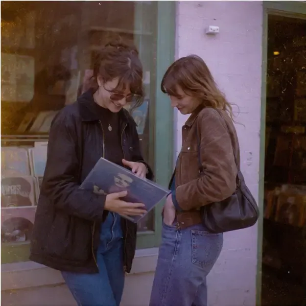Friends outside a record shop in the Expired Roll style