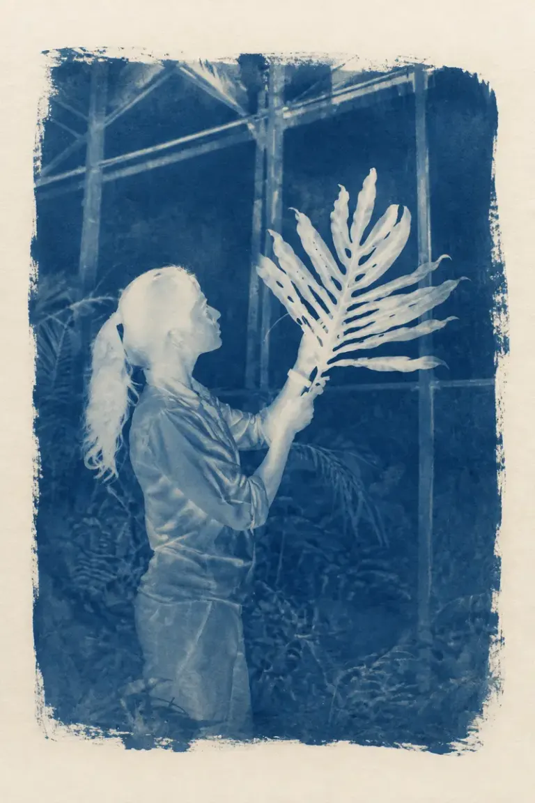 Botanist holding a fern in a glasshouse in the Sunprint Atlas style