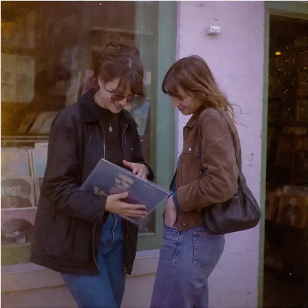 Friends outside a record shop in the Expired Roll style